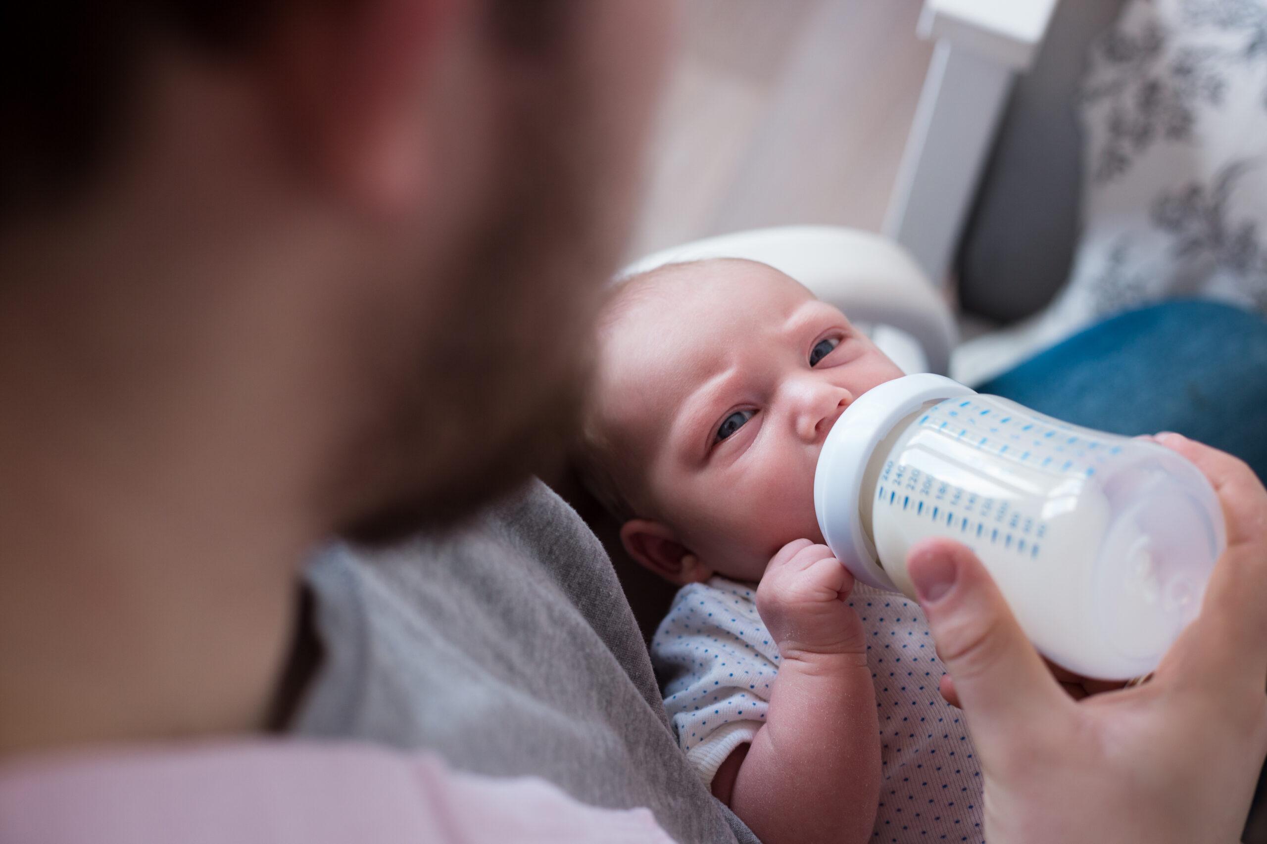 Young father feeding his newborn daughter. Lifestyle image, natu